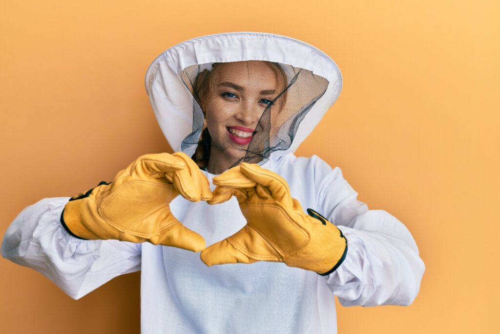 Beekeeper making heart with hands