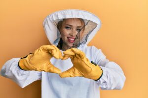 Beekeeper making heart with hands